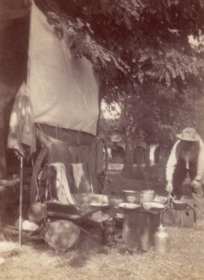 Carl Ahrens cooking supper at a camp during the California journey