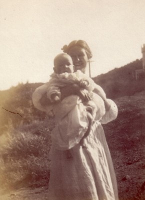 Madonna holding baby Laird outdoors