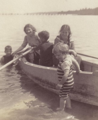 Children beside a small boat at Leith