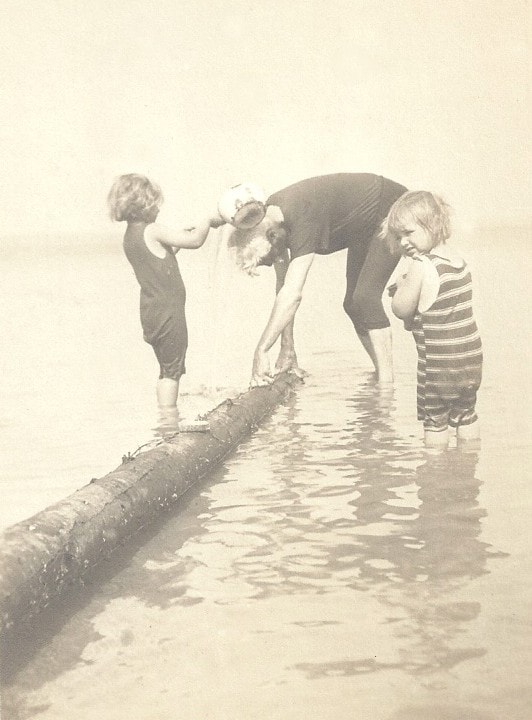Sigrid and Chloris with Carl Ahrens wading beside a log at Leith