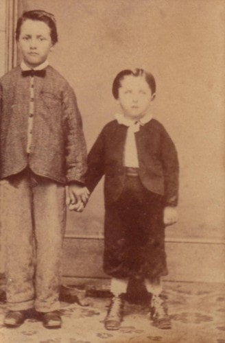 Two young boys holding hands in a studio portrait, circa 1864, Berlin Ontario — Carl Ahrens is the younger boy on the right