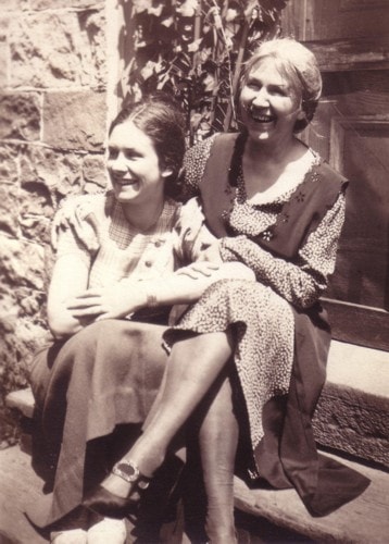 Madonna Ahrens and daughter Sigrid laughing together on steps at Big Trees, Galt, Ontario, 1933