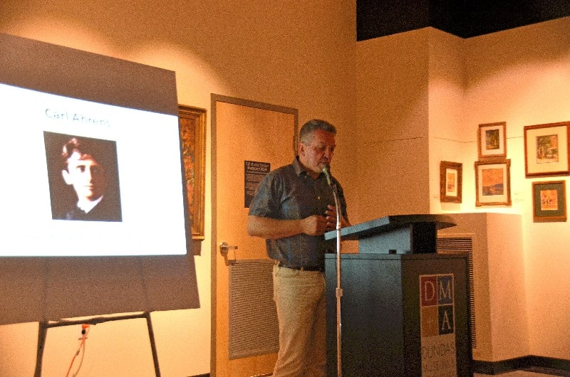 Sandu Sindile (curator) welcoming everyone to Kim Bullock's speech on Carl Ahrens