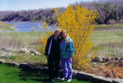 Deb and Kim by a flowering tree at the reservation
