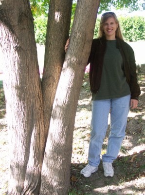 Kim beside a tree at the reservation