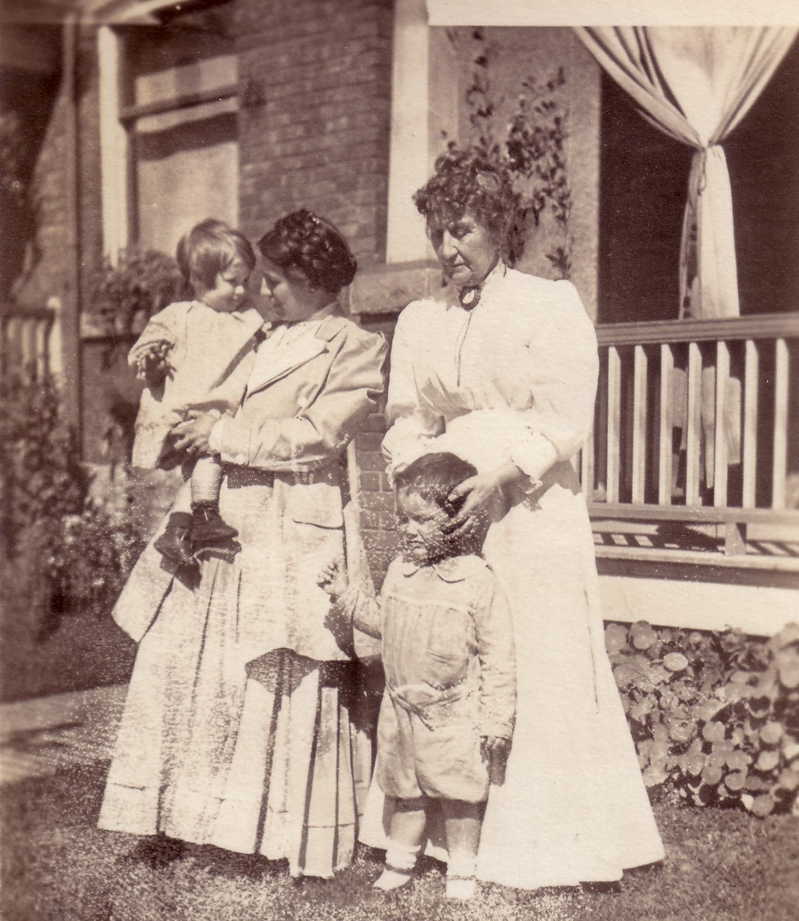 Laird, Penelope, Madonna, and Isabella on a porch