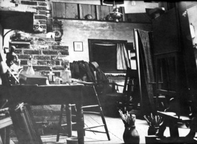 Interior of the Lambton Mills studio with brick walls and art supplies
