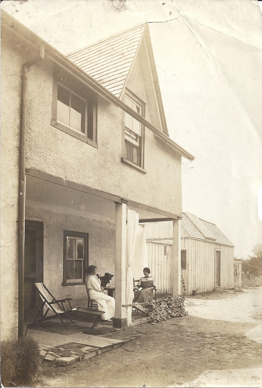 Back porch of the Lambton Mills home with two seated figures