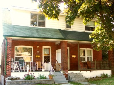 Red brick Toronto residence with a covered front porch